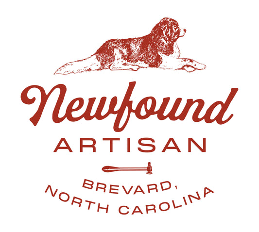 Newfound Artisan logo - A newfoundland dog laying down over the words Newfound Artisan. Below that is a sideways hammer and below that are the words Brevard, North Carolina.